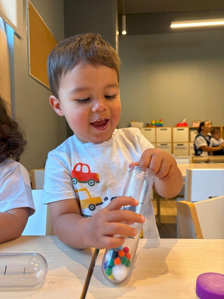 Lenguaje verbal, pequeño jugando con pequeñas bolas de tela, aprendiendo en Colegio APDE Connections Cayalá